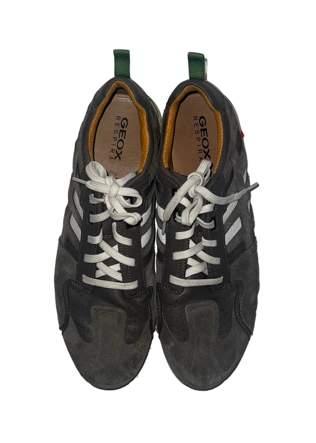 A pair of black Geox low-top sneakers with white laces and white side stripes, displayed flat on a white surface with red paint strokes.