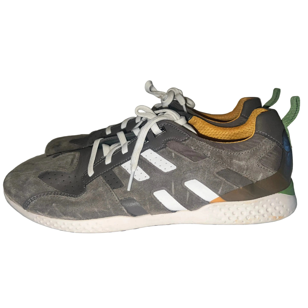 A pair of Geox sneakers in dark gray suede and synthetic mesh, featuring white three-stripes, white laces, a yellow-orange mesh lining, and a white textured midsole.