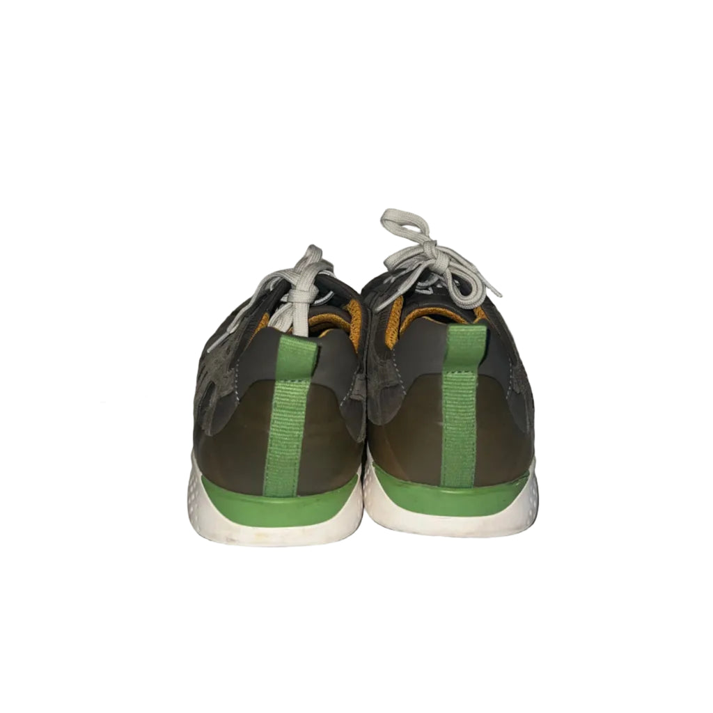 A pair of low-top athletic sneakers shown from the back, featuring a dark gray and olive green upper with bright green heel accents, white laces, and a white midsole.