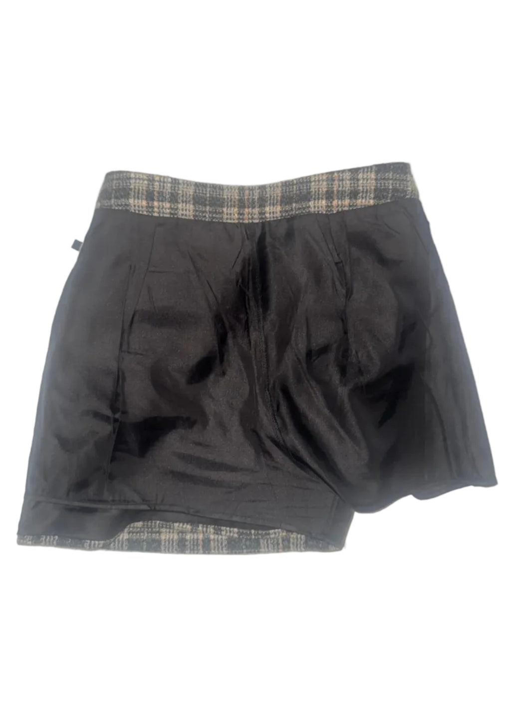 A black skirt with a beige and black plaid waistband and hem, laid flat on a white tiled floor.