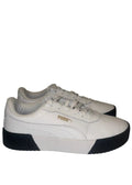 A pair of white Puma platform sneakers with black midsoles and gold branding