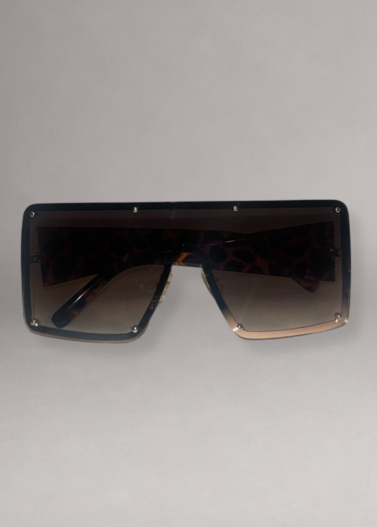 A pair of oversized shield sunglasses with a dark tortoiseshell pattern and gradient brown lenses.