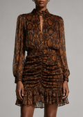 A model wearing a brown and black snakeskin-patterned long-sleeve mini dress with a ruffled hem.
